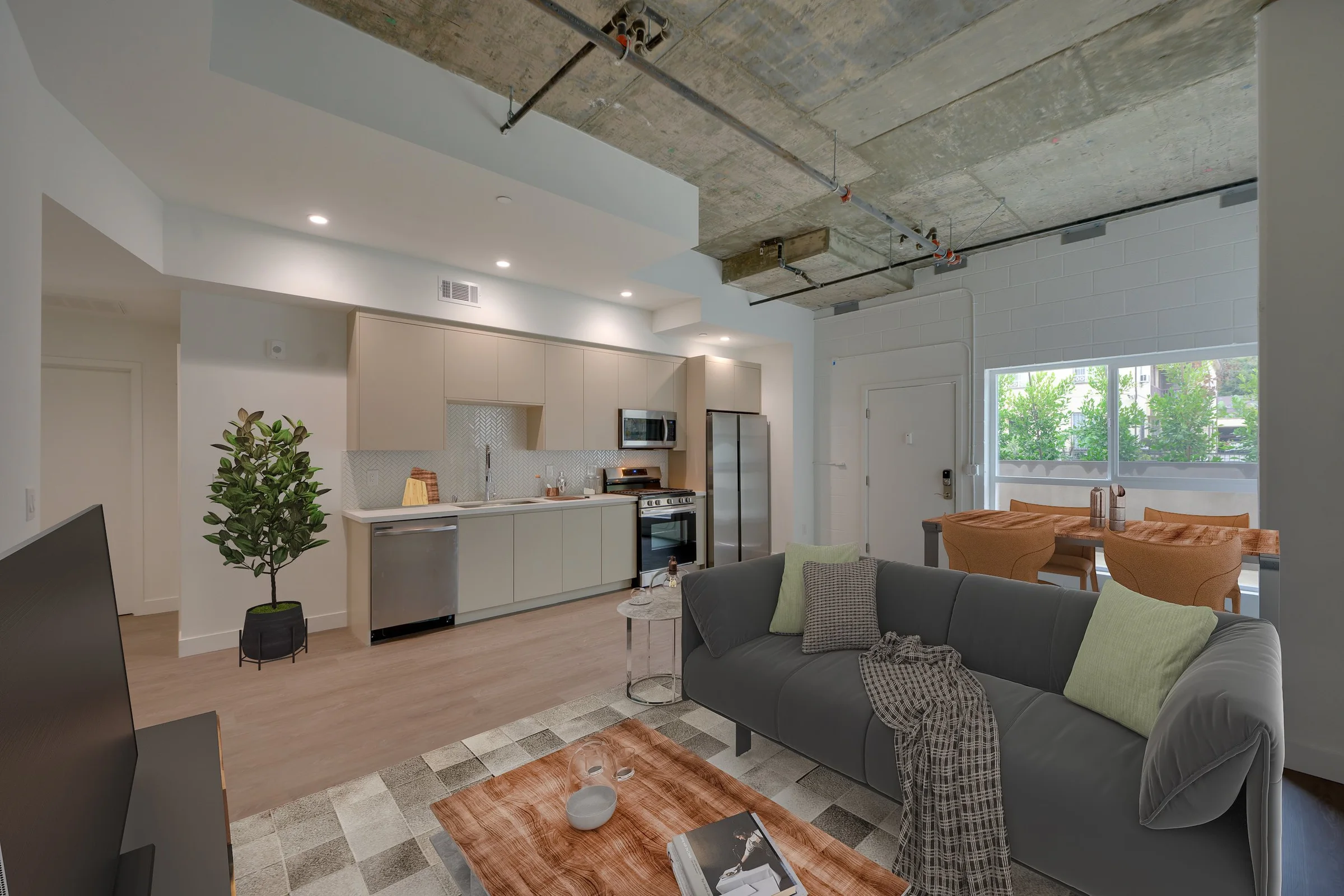 Pine on Gramercy kitchen opening to a furnished living room