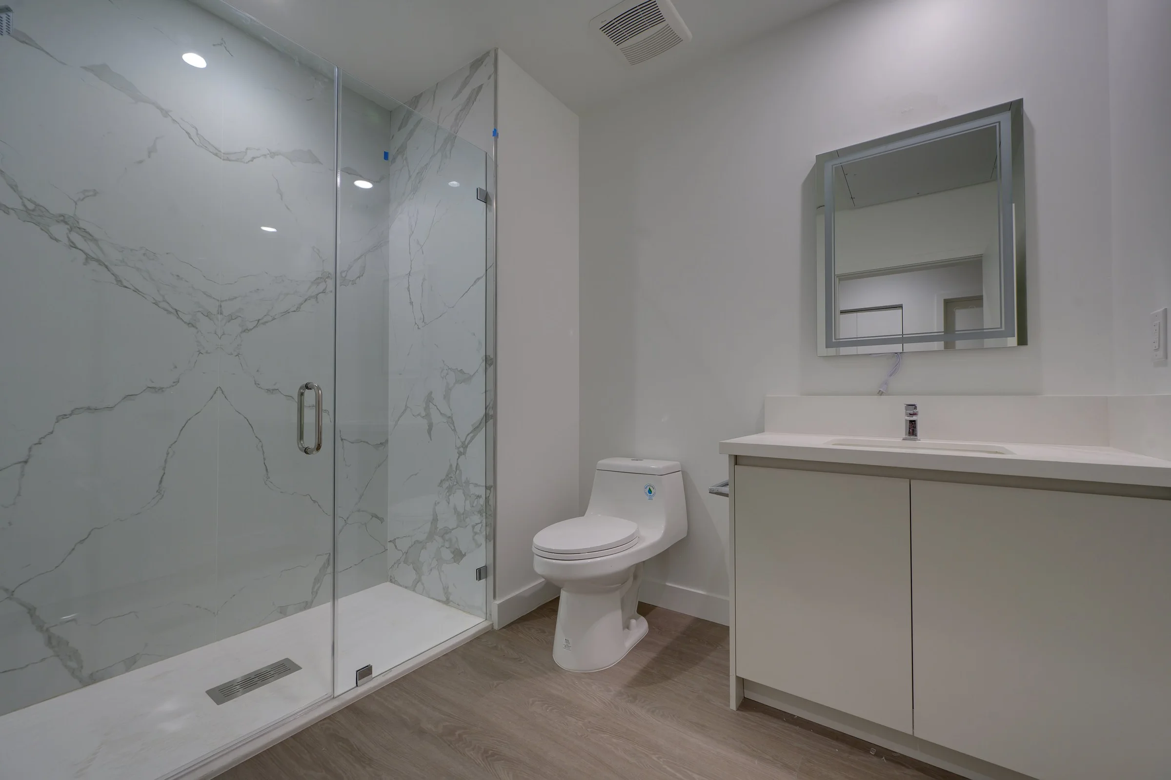 Pine on Gramercy bathroom with glass shower and wide vanity