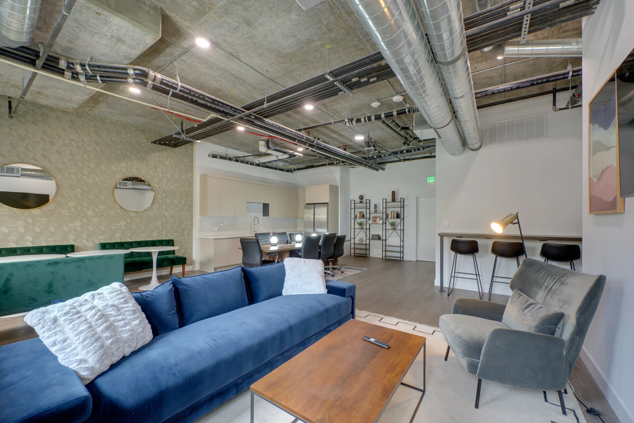 Pine on Gramercy resident lounge with sofa, work table, and kitchenette